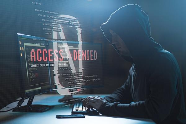 hacker with access denied messages on computer