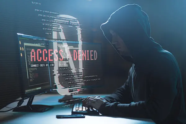 hacker with access denied messages on computer